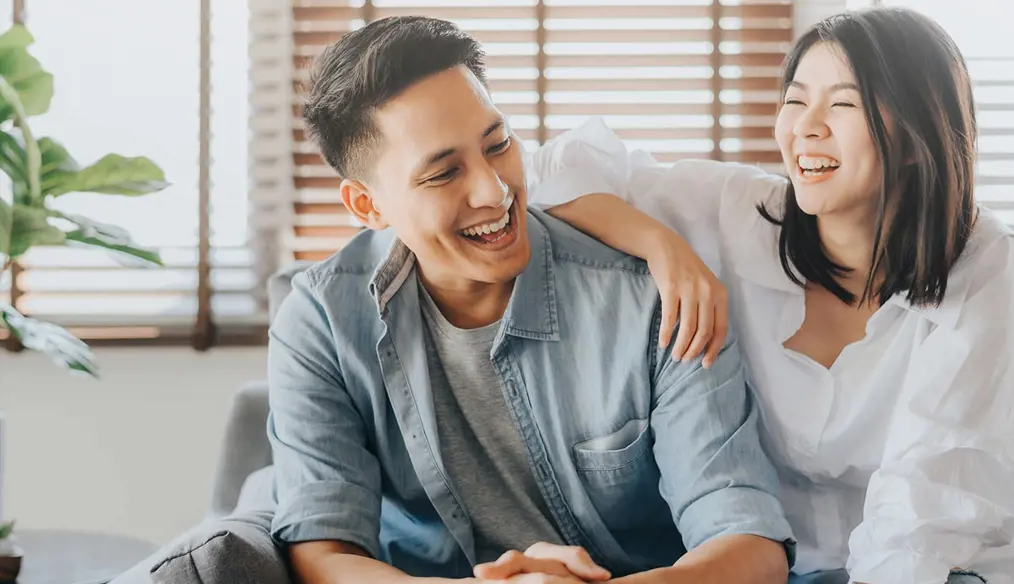 Young couple smiling & laughing