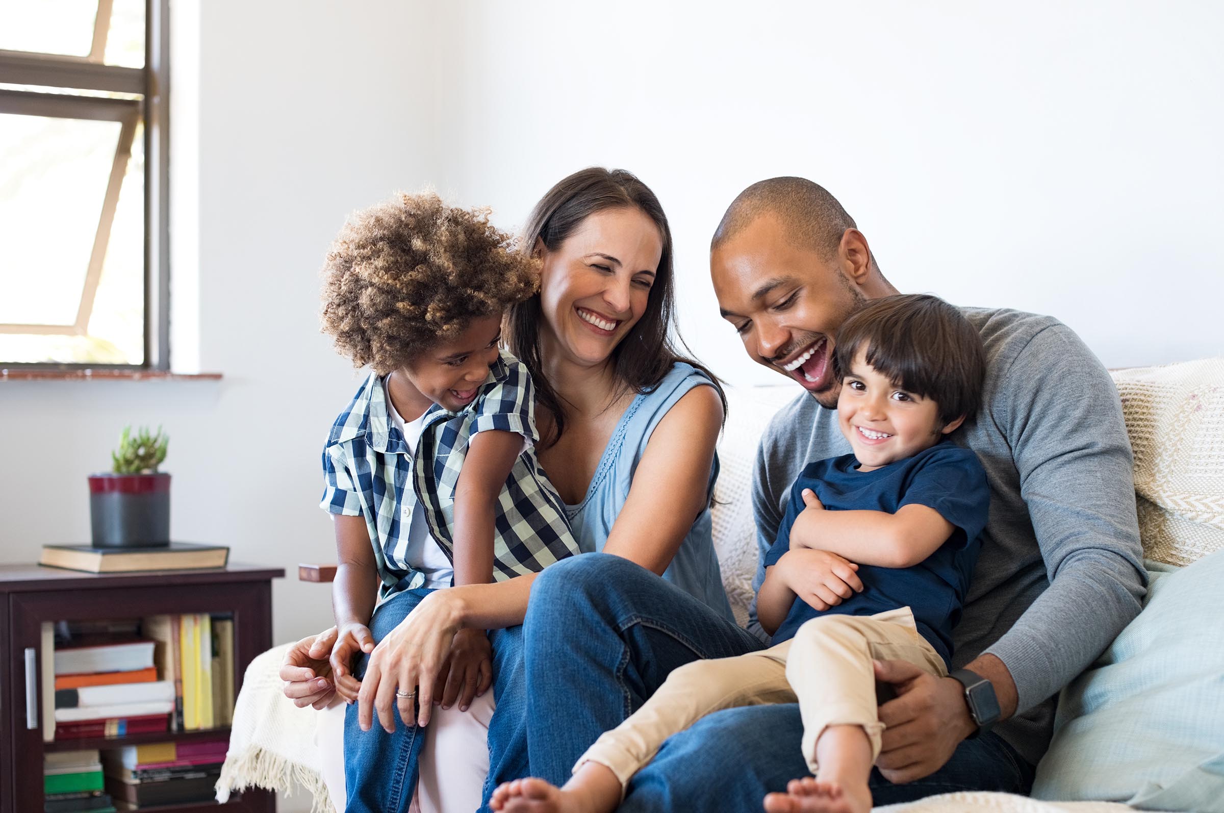 laughing multiracial family with two kids