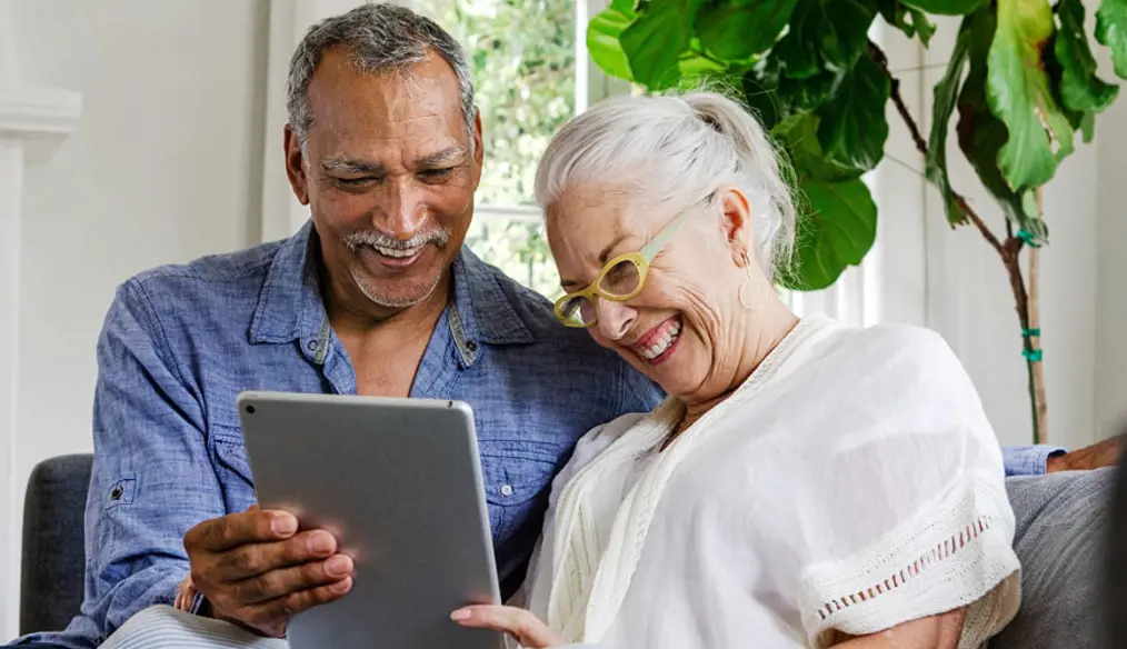 Couple looking at the ipad happily