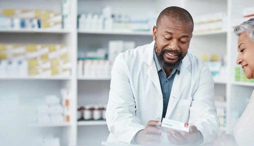 Woman speaking to pharmacist about her medication