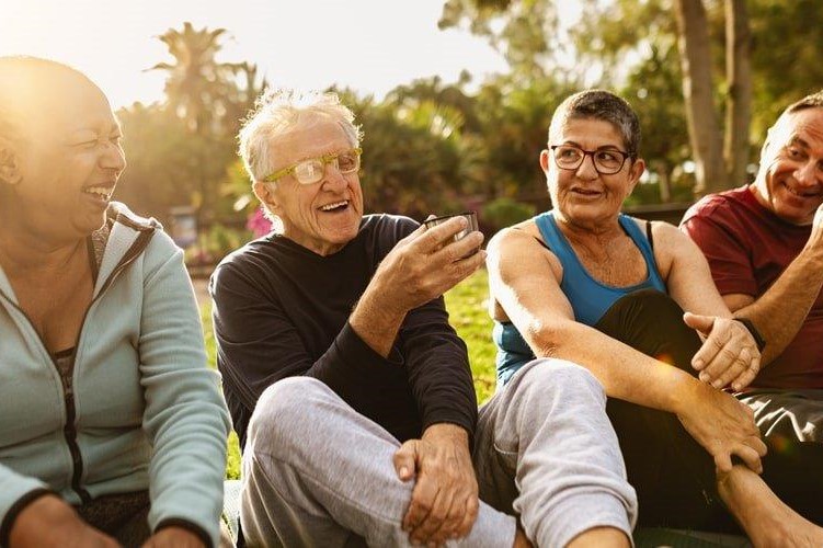 several older adults sitting and laughing