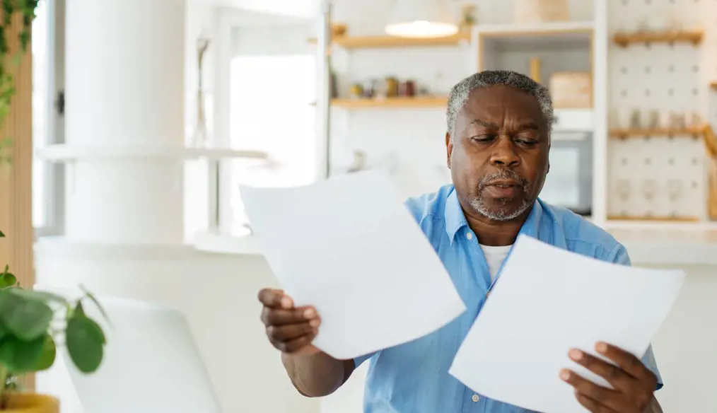 Man holding pieces of paper