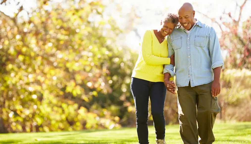 Happy African American couple holding hands and walking