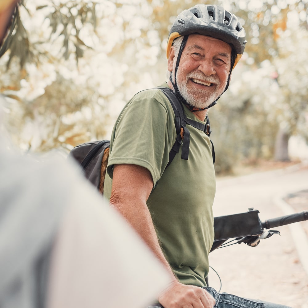 smiling man wearing a bike helmet